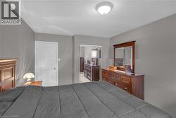 Room featuring a white interior door with a brass-tone knob, light gray painted walls, and a white ceiling with a flush-mount light fixture - 