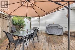 Expansive wooden deck with a privacy fence and a gazebo structure - 