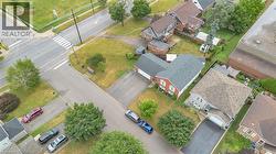 Aerial perspective showcasing a residential property with a red brick facade and a dark gray shingled roof - 