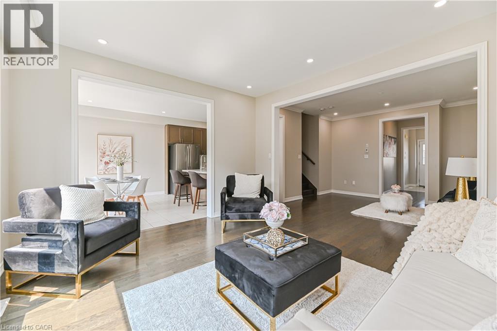 Sophisticated primary suite showcasing wood-finish flooring, recessed ceiling lighting, and dual walk-in closets with built-in shelving - 24 Weatherall Avenue, Cambridge, ON - Indoor Photo Showing Living Room