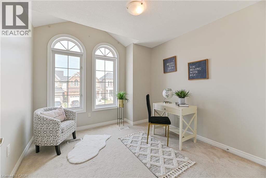 Two arched windows, sloped ceiling, light-toned wall paint, and recessed lighting - 24 Weatherall Avenue, Cambridge, ON - Indoor