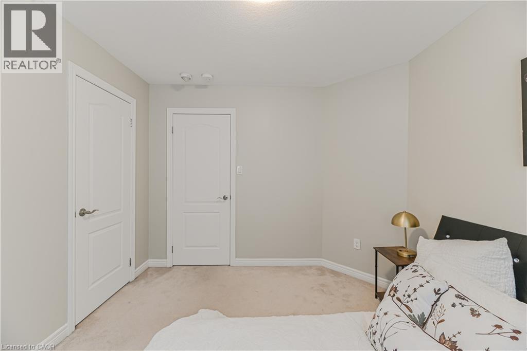 Neutral wall paint, light-colored carpeting, and white trim - 24 Weatherall Avenue, Cambridge, ON - Indoor Photo Showing Bedroom
