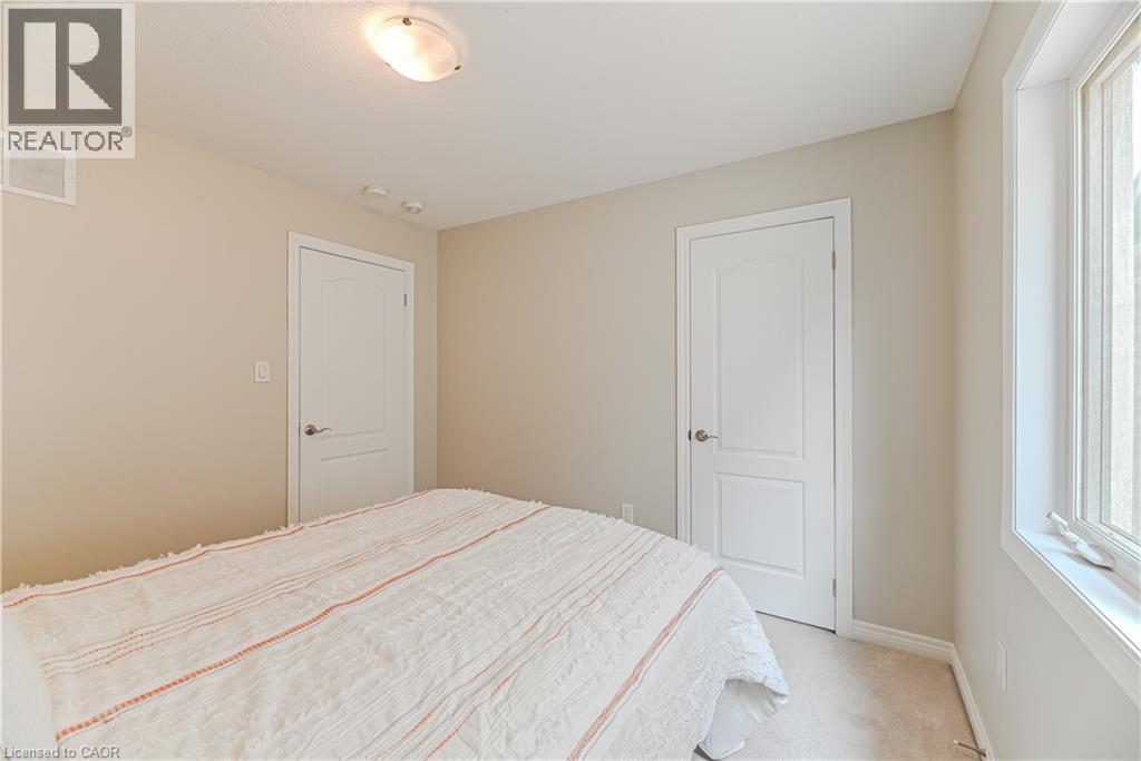 Neutral wall tones, carpeted flooring, and a window with vertical blinds - 24 Weatherall Avenue, Cambridge, ON - Indoor Photo Showing Bedroom