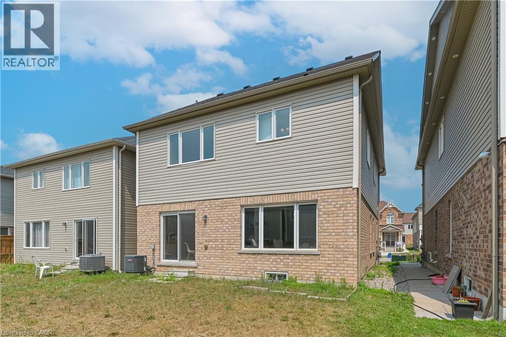 Exterior rear elevation with brick and siding, multiple windows, and a sliding glass door - 24 Weatherall Avenue, Cambridge, ON - Outdoor With Exterior