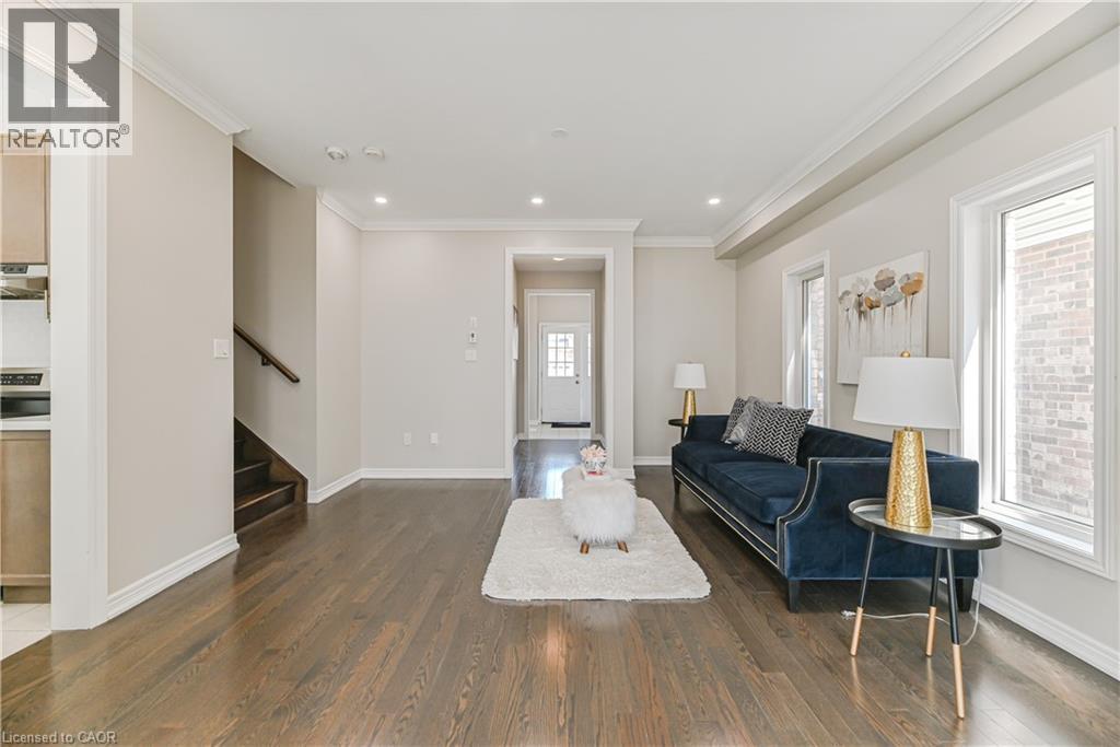 Hardwood flooring, recessed lighting, crown molding, and multiple windows - 24 Weatherall Avenue, Cambridge, ON - Indoor Photo Showing Living Room