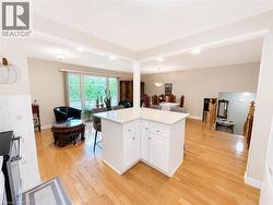 Open-concept living area featuring wood-finish flooring - 