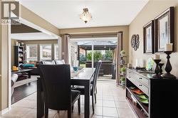Tiled flooring, overhead light fixture, sliding glass door, backyard patio, and a gazebo structure - 