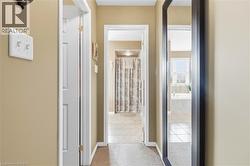 Hallway featuring neutral wall paint, white trim, and carpet flooring - 