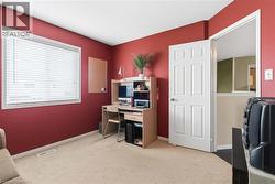 Room featuring neutral carpeting, a single window with horizontal blinds, and a white six-panel interior door - 