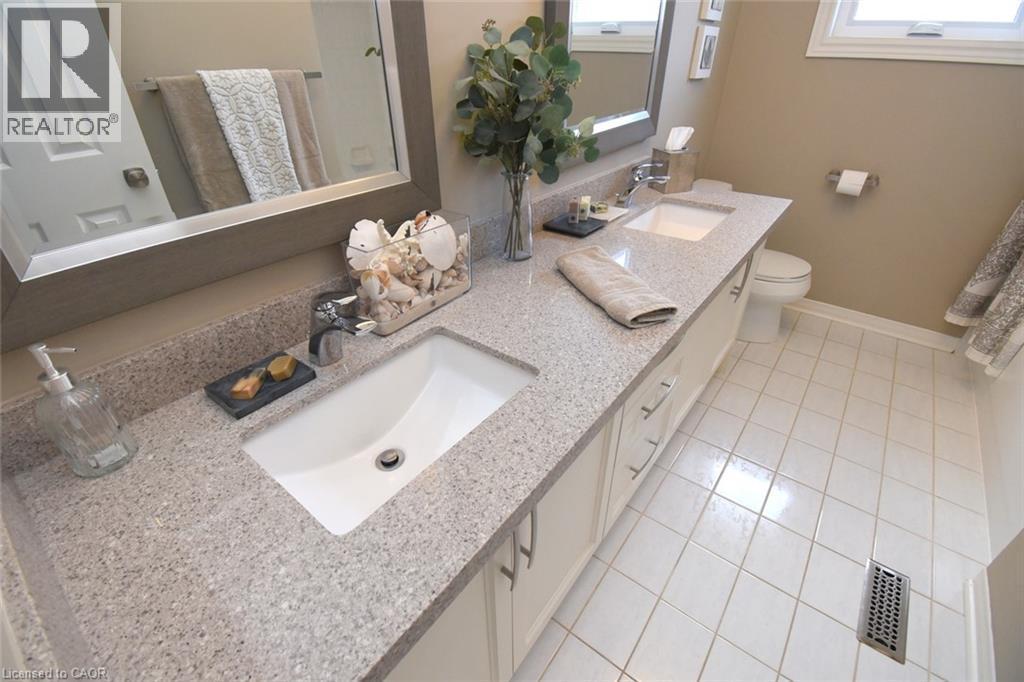 Dual undermount sinks with light-toned countertops - 470 Amanda Crescent, Burlington, ON - Indoor Photo Showing Bathroom