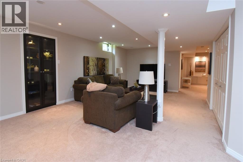 Recessed lighting, light-toned carpeting, built-in display cabinetry with glass doors, and panel-style closet doors - 470 Amanda Crescent, Burlington, ON - Indoor