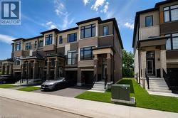 Contemporary townhouse exterior featuring a multi-tone facade, prominent windows, and integrated garage access - 