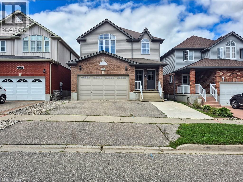 Brick and siding exterior with a dual-door entry and an arched transom window - 128 Udvari Crescent Unit# A, Kitchener, ON - Outdoor With Facade