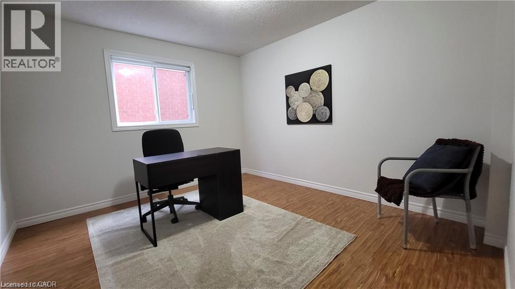 Wood-finish flooring, white wall paint, and white trim - 128 Udvari Crescent Unit# A, Kitchener, ON - Indoor