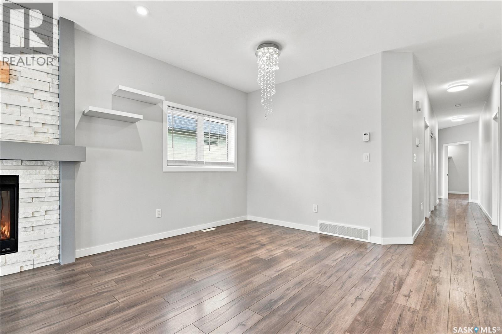 134 Bolstad Way, Saskatoon, SK - Indoor Photo Showing Other Room With Fireplace