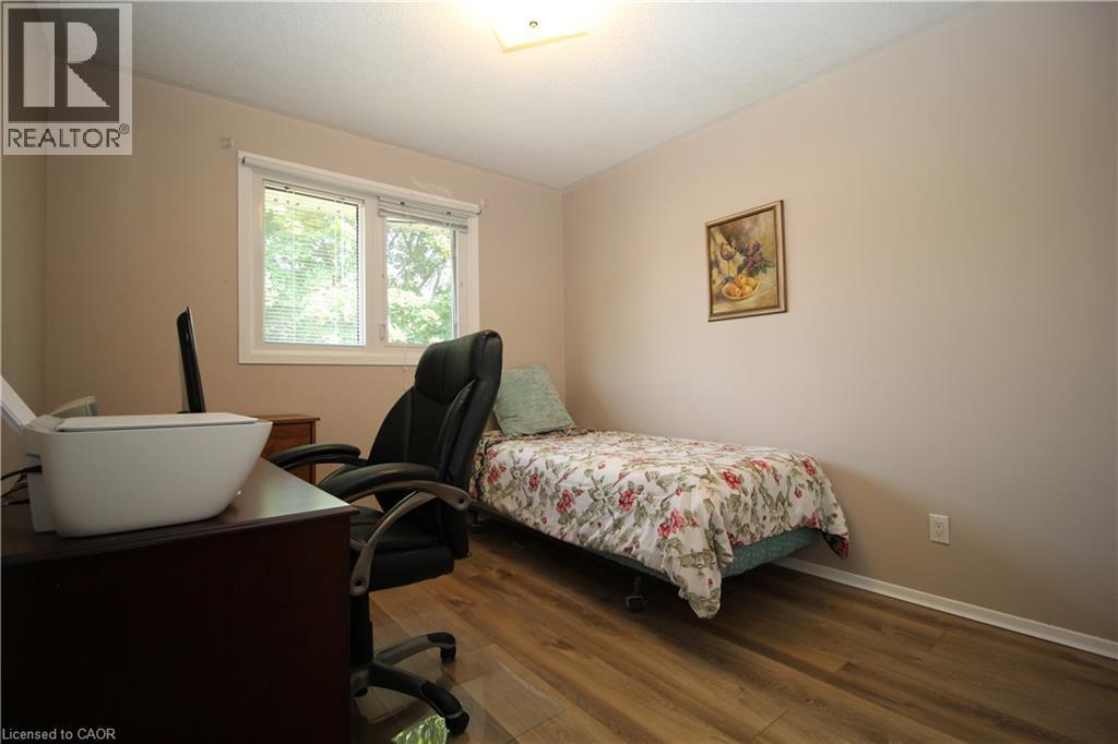 Laminate flooring, neutral wall tones, and overhead lighting - 14 Berkley Crescent, Simcoe, ON - Indoor Photo Showing Bedroom
