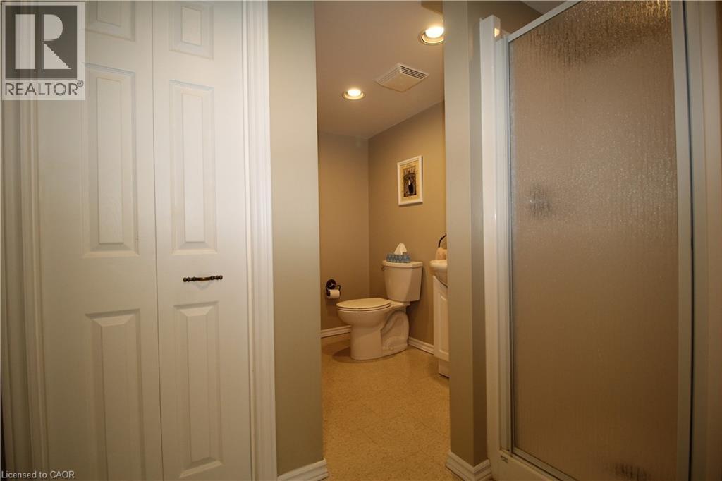 Dedicated powder room featuring warm neutral finishes, recessed ceiling lighting, and ceramic tile flooring - 14 Berkley Crescent, Simcoe, ON - Indoor Photo Showing Bathroom