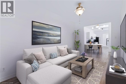 Recessed lighting, wood-finish flooring, and a contemporary ceiling light fixture - 442 King William Street, Hamilton, ON - Indoor Photo Showing Living Room