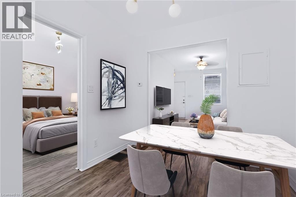 Open concept dining area featuring a marble-patterned tabletop, wood-finish flooring, and recessed lighting - 442 King William Street, Hamilton, ON - Indoor
