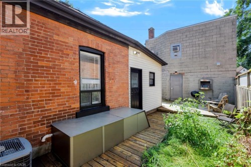 Brick exterior with black trim window - 442 King William Street, Hamilton, ON - Outdoor With Deck Patio Veranda With Exterior