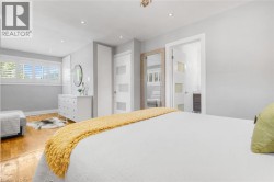 Wood-finish flooring, recessed lighting, and white plantation shutters - 