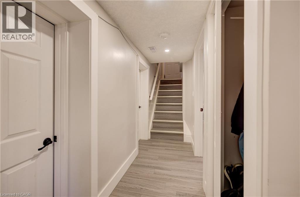 Hallway featuring wood-finish flooring, recessed lighting, and a stairway with carpeted treads - 361 Prospect Avenue, Kitchener, ON - Indoor Photo Showing Other Room