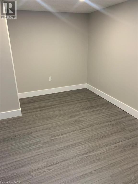 Interior room with neutral-toned walls, wood-finish flooring, white trim, and recessed lighting - 361 Prospect Avenue, Kitchener, ON - Indoor Photo Showing Other Room