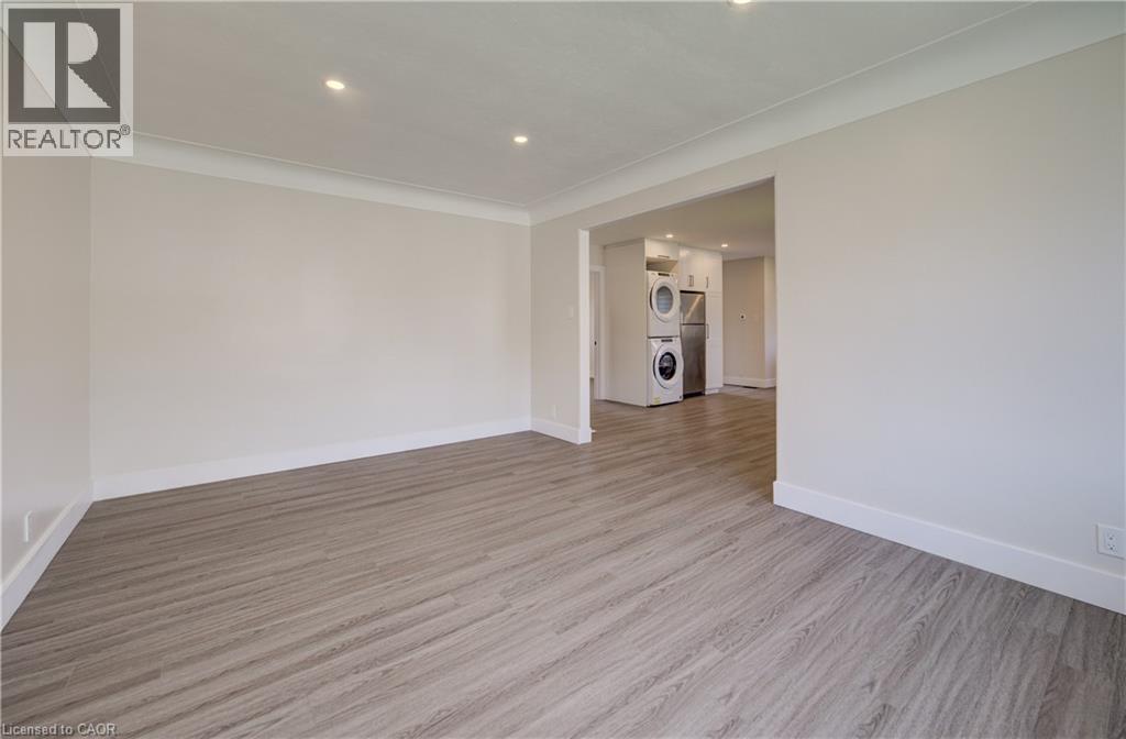 Spacious room featuring wood-finish flooring, recessed lighting, and crown molding - 361 Prospect Avenue, Kitchener, ON - Indoor Photo Showing Other Room
