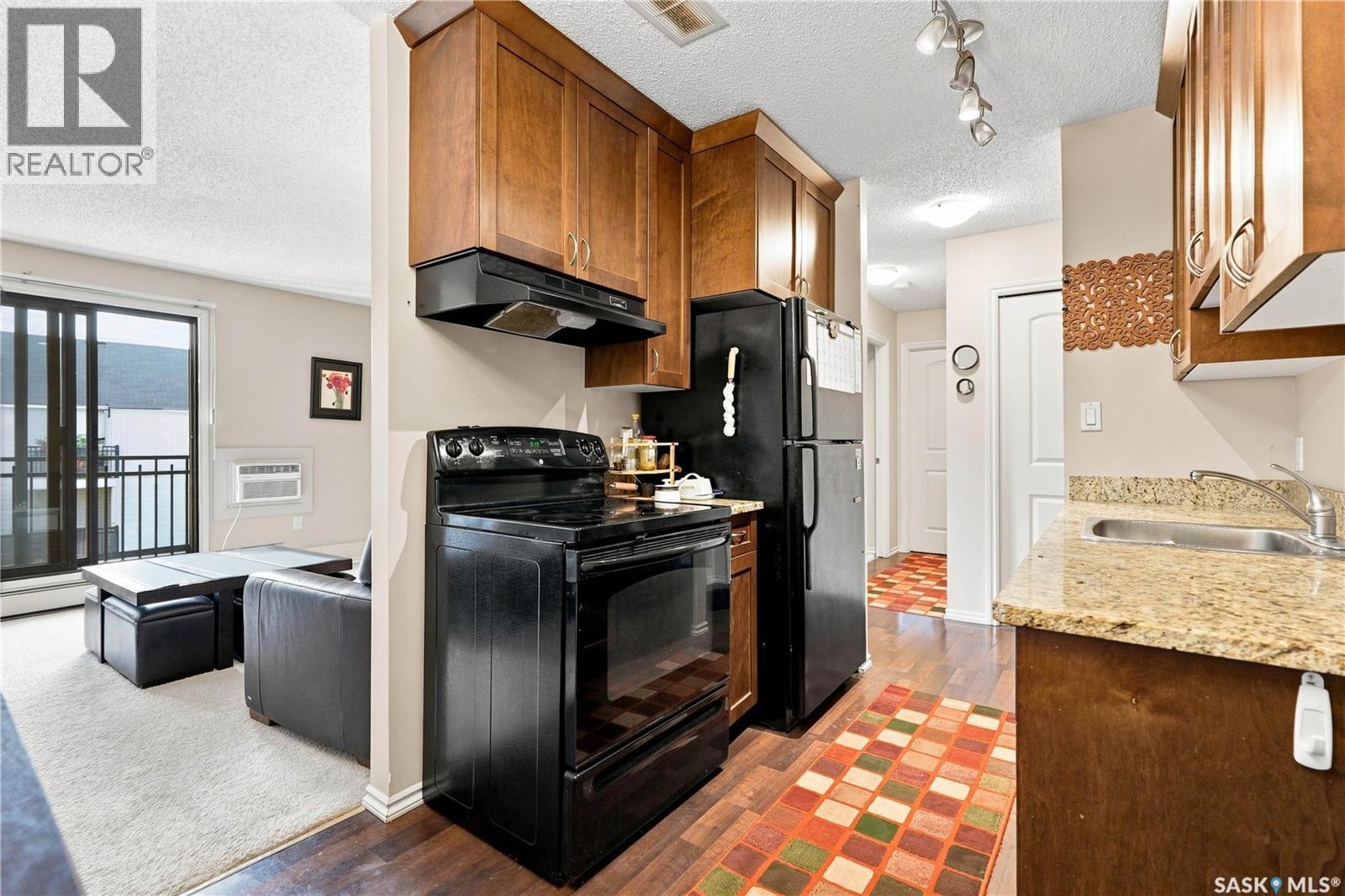 303 258 Pinehouse Place, Saskatoon, SK - Indoor Photo Showing Kitchen With Fireplace