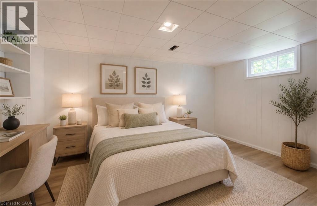 Wood-finish flooring, white paneled walls, built-in shelving, and recessed lighting - 244 Royal Street, Waterloo, ON - Indoor Photo Showing Bedroom