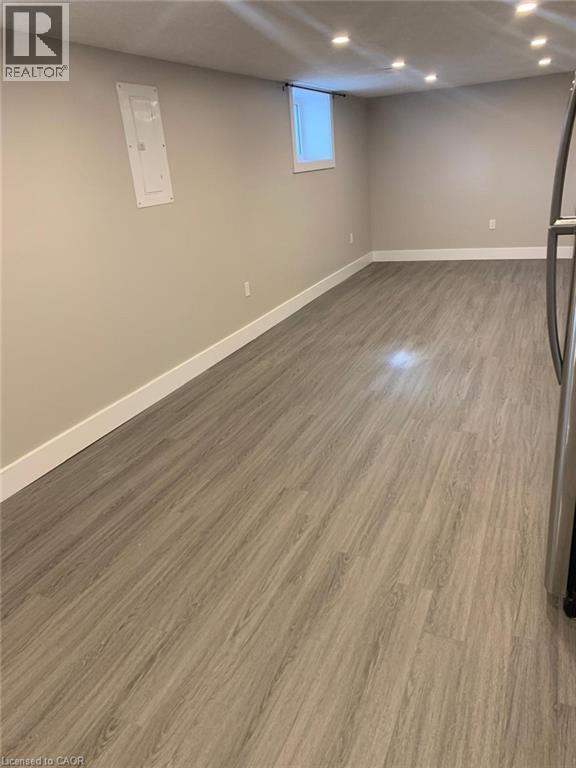 Recessed lighting illuminates wood-finish flooring - 361 Prospect Avenue, Kitchener, ON - Indoor