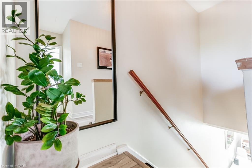Hardwood handrail on white walls - 2488 Brookhurst Road, Mississauga, ON - Indoor Photo Showing Other Room