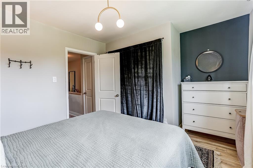Recessed lighting, wood-finish flooring, two-panel interior doors, and a gold-tone semi-flush mount light fixture - 2488 Brookhurst Road, Mississauga, ON - Indoor Photo Showing Bedroom