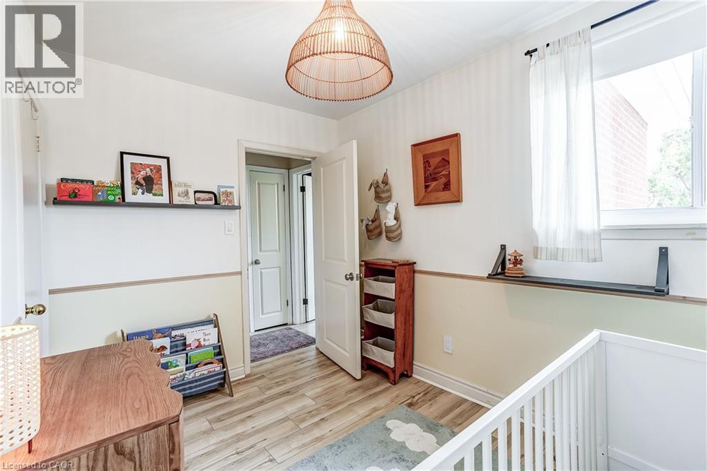 Wood-finish flooring, white walls, and a window with a built-in shelf - 2488 Brookhurst Road, Mississauga, ON - Indoor Photo Showing Other Room