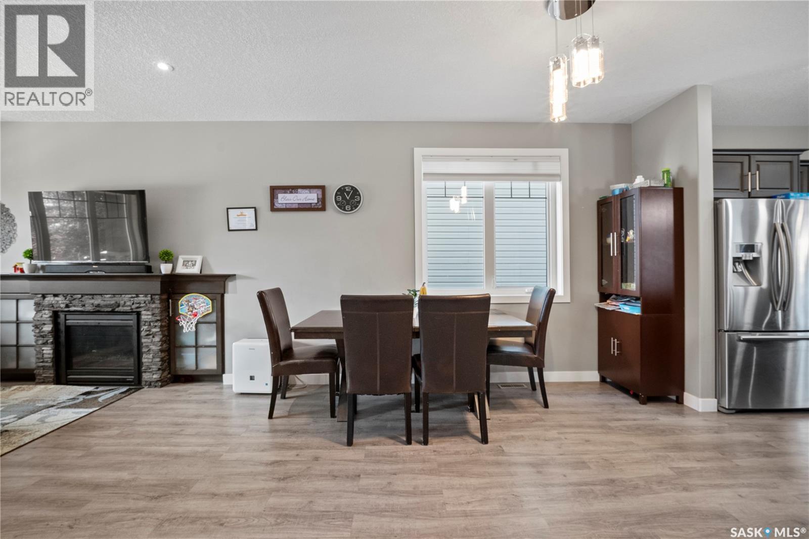 8726 Archer Lane, Regina, SK - Indoor Photo Showing Dining Room With Fireplace