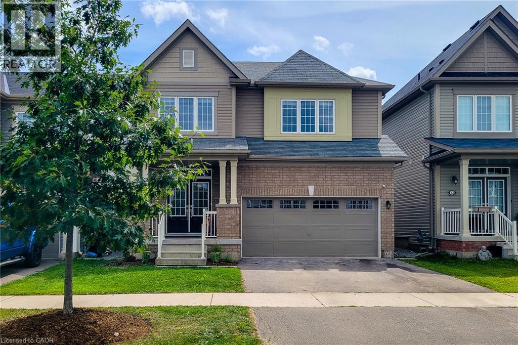 Two-story property featuring a brick and siding exterior, an attached two-car garage, and a covered front porch - 11 Esther Crescent, Thorold, ON - Outdoor With Facade