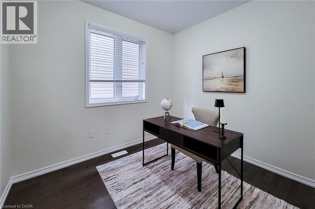 Wood-finish flooring, white trim, and a window with blinds - 11 Esther Crescent, Thorold, ON - Indoor Photo Showing Other Room