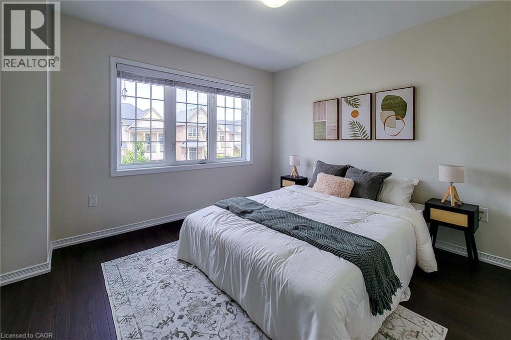 White walls, dark wood-finish flooring, and a large multi-pane window - 11 Esther Crescent, Thorold, ON - Indoor Photo Showing Bedroom