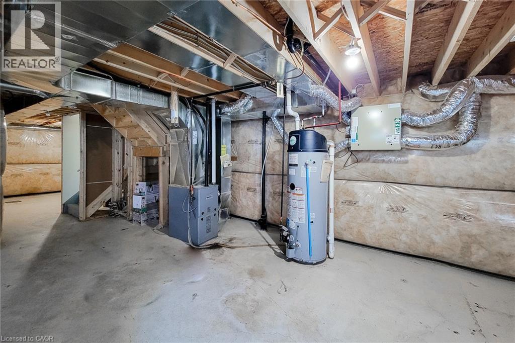 Unfinished basement with concrete flooring, exposed ceiling joists, and visible utility systems - 11 Esther Crescent, Thorold, ON - Indoor Photo Showing Basement