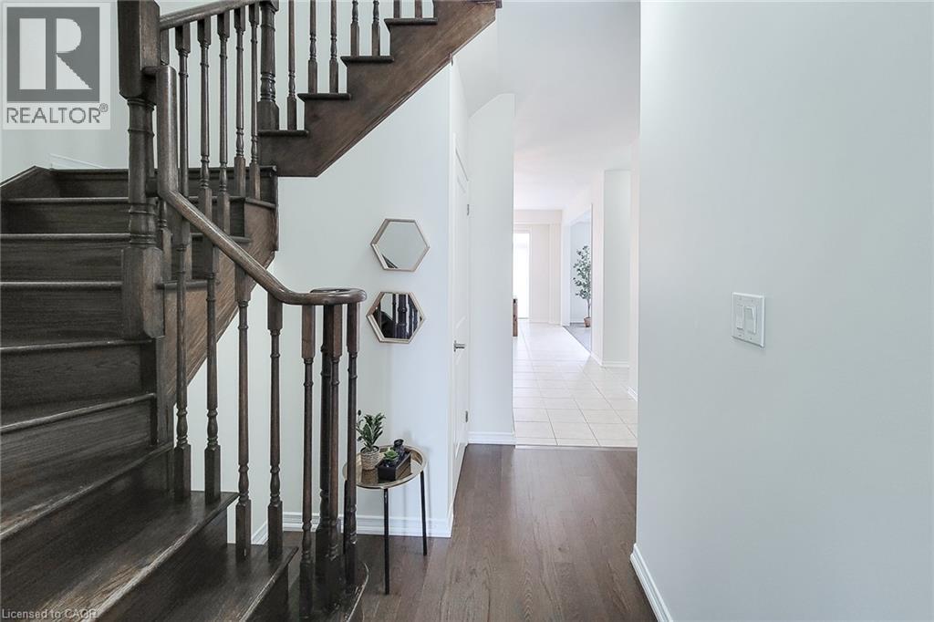 Hardwood staircase with turned balusters and dark wood-finish treads - 11 Esther Crescent, Thorold, ON - Indoor Photo Showing Other Room