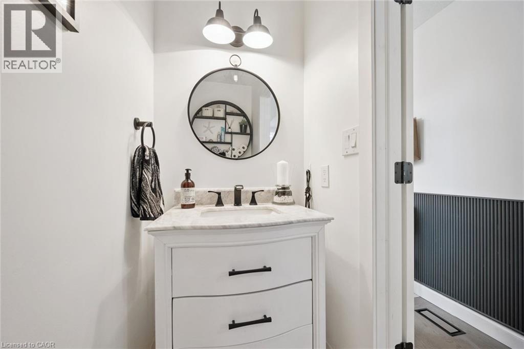 White vanity with a light-toned countertop, under-mount sink, and matte black faucet - 439 Beaver Creek Road, Waterloo, ON - Indoor Photo Showing Bathroom