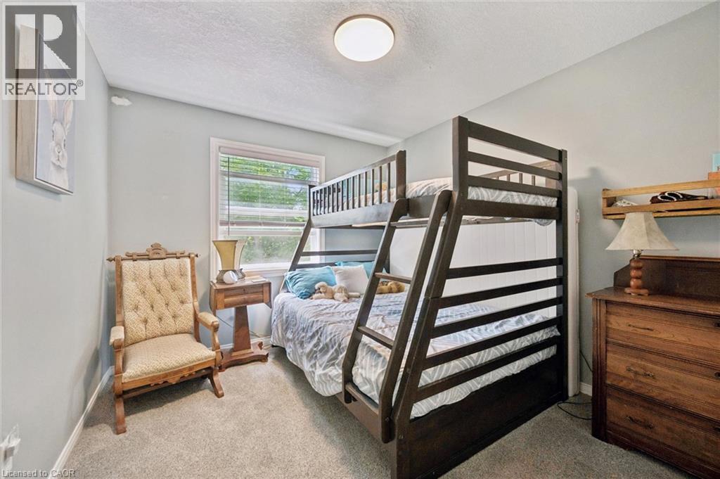 Neutral-toned wall paint and carpeting throughout - 439 Beaver Creek Road, Waterloo, ON - Indoor Photo Showing Bedroom