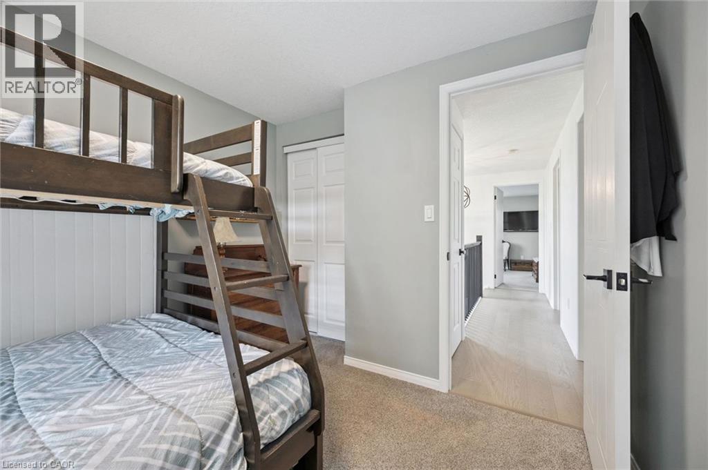 Carpeted flooring, shaker-style closet doors, and light gray wall paint - 439 Beaver Creek Road, Waterloo, ON - Indoor Photo Showing Bedroom