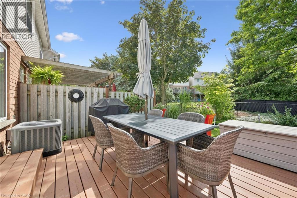 Expansive wood deck with a privacy fence, established pergola, and mature trees - 439 Beaver Creek Road, Waterloo, ON - Outdoor With Deck Patio Veranda