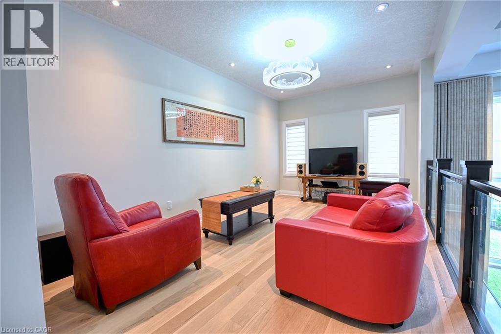 Hardwood-style flooring throughout, recessed lighting, and a modern ceiling fixture - 923 Eaglecrest Court, Kitchener, ON - Indoor Photo Showing Living Room