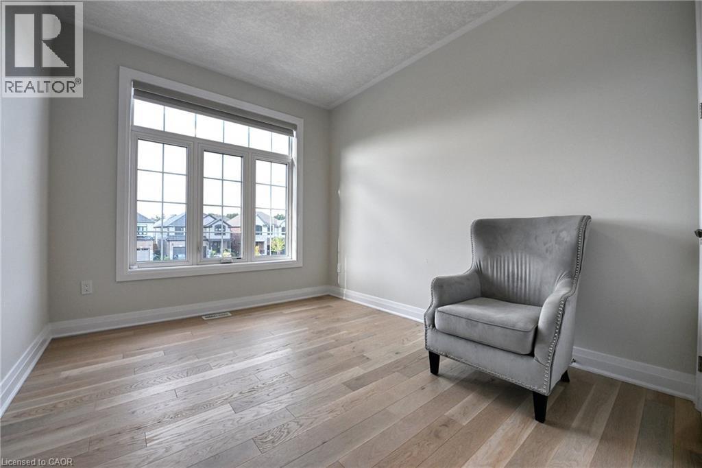 Expansive window with white trim, wood-finish flooring, and light-toned walls - 923 Eaglecrest Court, Kitchener, ON - Indoor