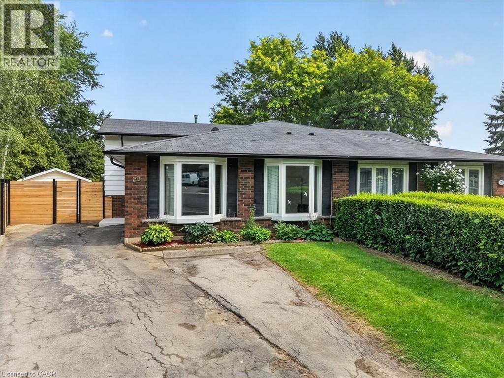 Brick exterior featuring bay windows and dark shutters - 27 Gretna Court, Hamilton, ON - Outdoor