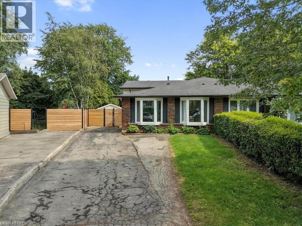 Brick exterior with a dark shingle roof - 27 Gretna Court, Hamilton, ON - Outdoor