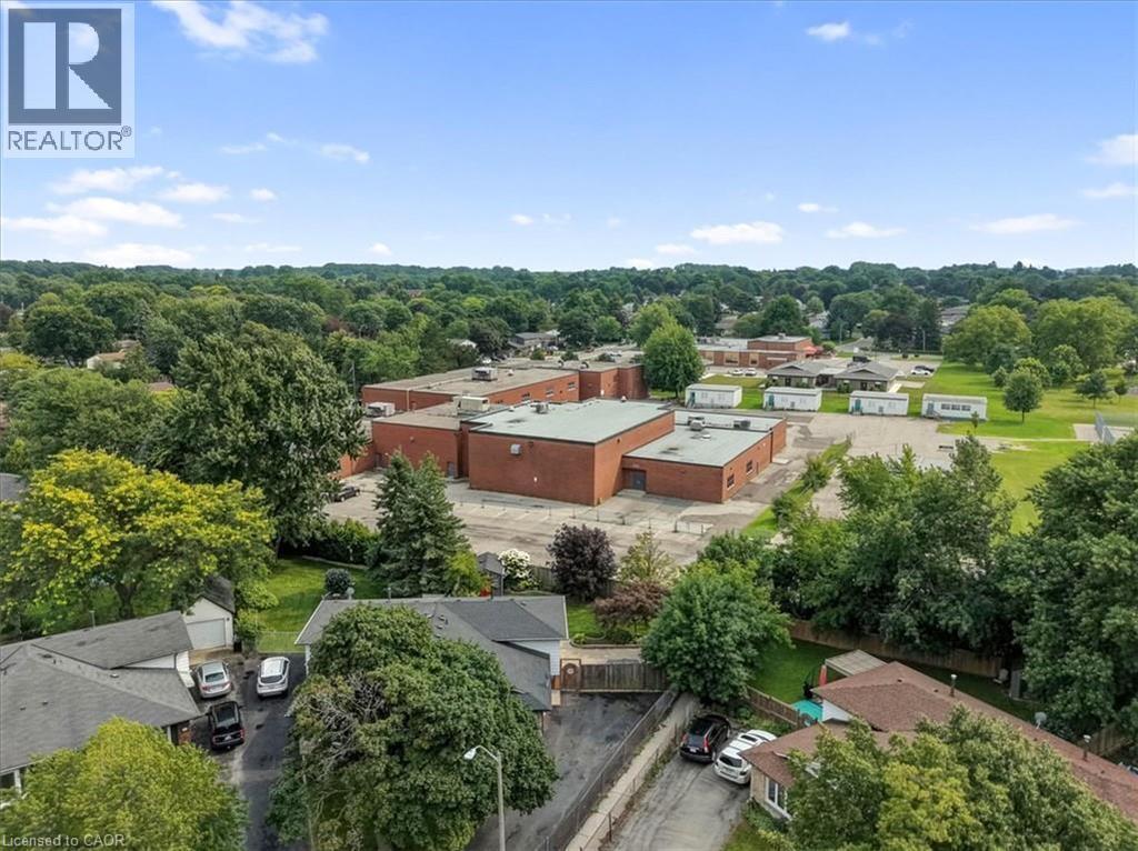 Aerial perspective showcasing residential rooftops and ample surrounding greenery - 27 Gretna Court, Hamilton, ON - Outdoor With View