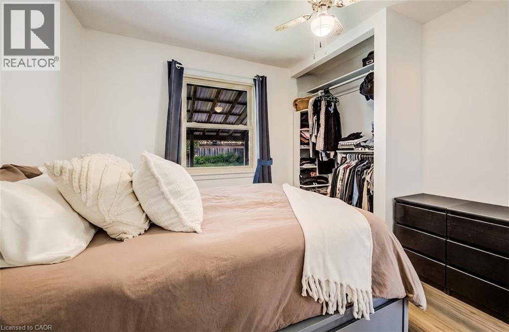 Recessed open closet with built-in shelving and hanging rods - 34 St Clair Avenue, Kitchener, ON - Indoor Photo Showing Bedroom